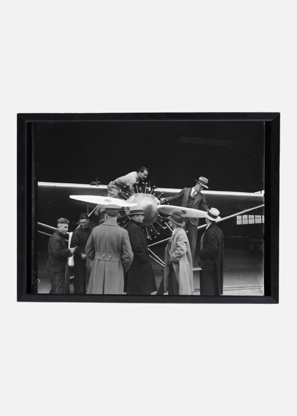 CHARLES LINDBERGH IN FRONT OF AIRPLANE