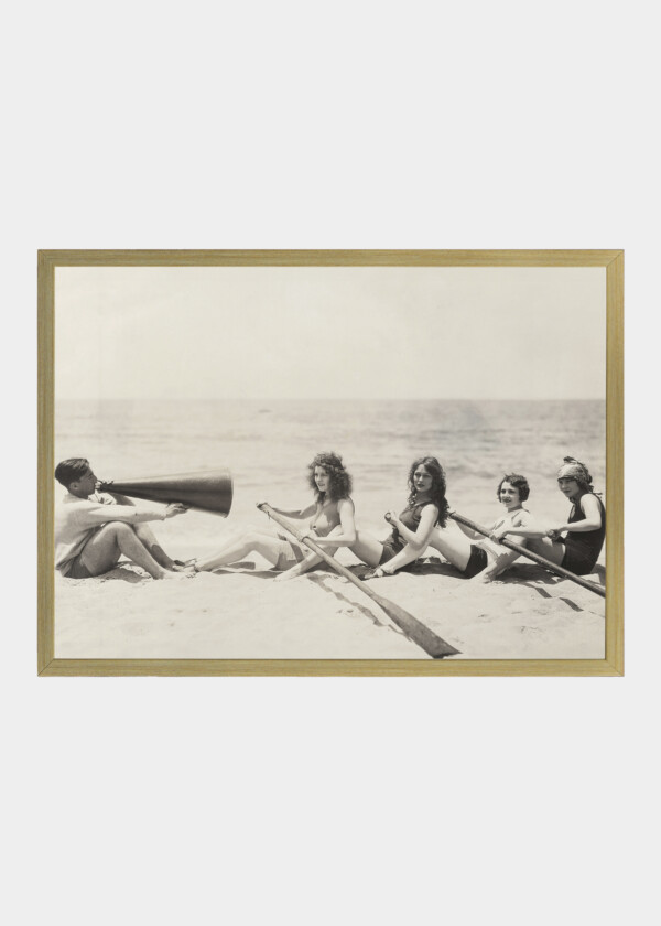 WOMEN PRACTICE ROWING ON THE BEACH