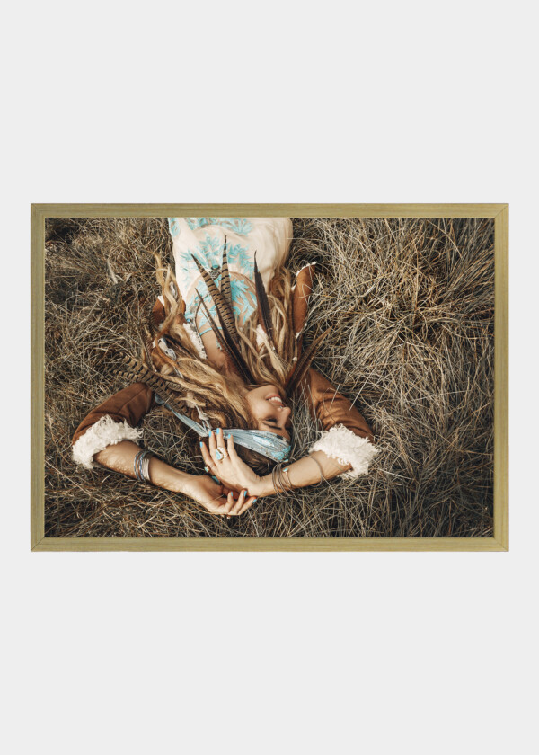 BEAUTIFUL YOUNG BOHO GIRL IN JACKET LYING DOWN ON GRASS