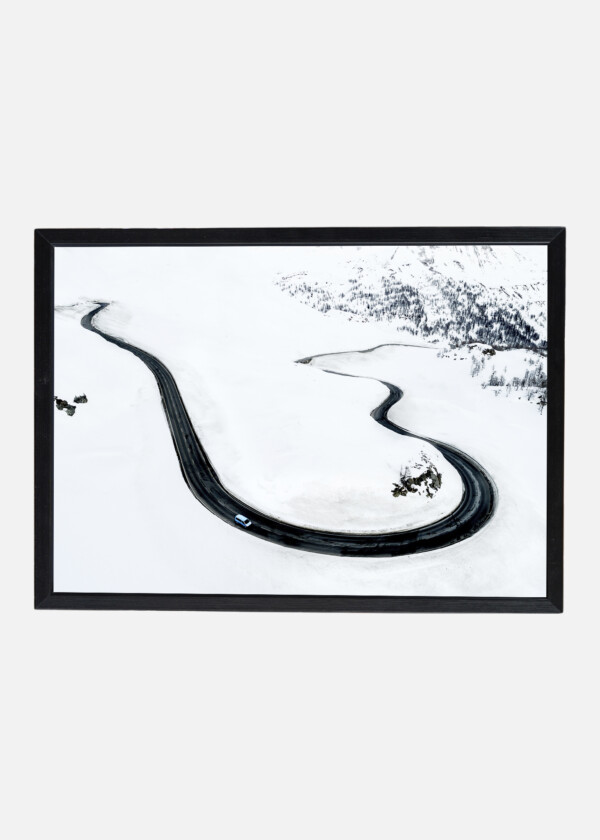 AERIAL VIEW OF A CAR TRAVERSING BERNINA PASS IN THE SWISS ALPS