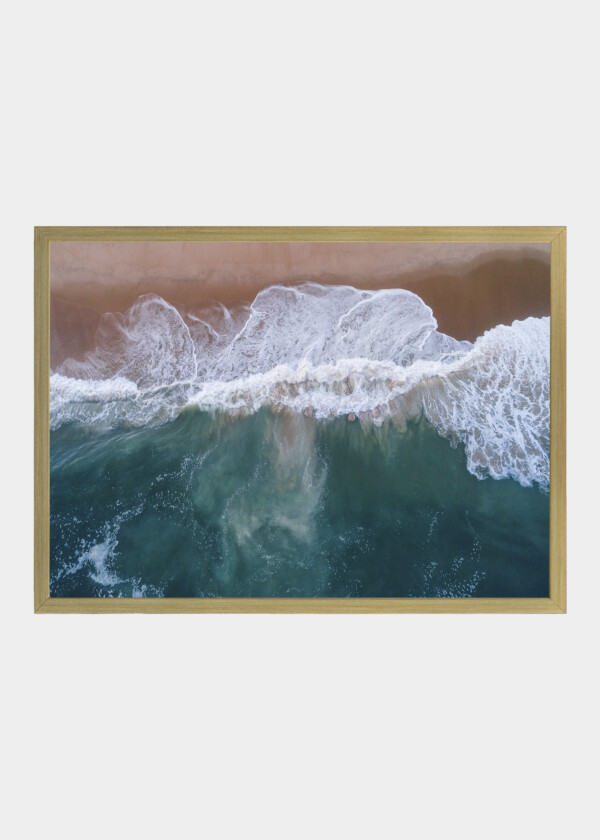 AERIAL VIEW LOOKING STRAIGHT DOWN AT LARGE WAVES CRASHING AGAINST A BEACH IN EAST HAMPTON, NEW YORK