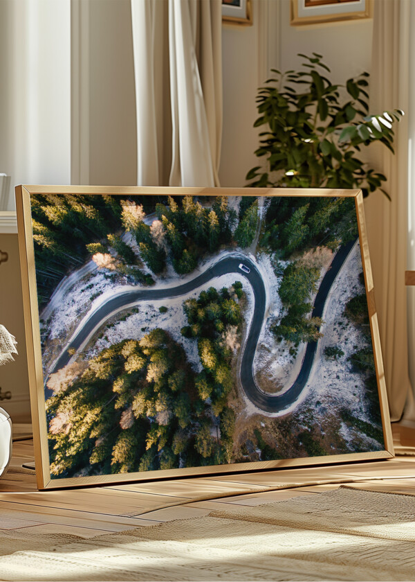 AERIAL VIEW OF SNOWY FOREST WITH A ROAD. CAPTURED FROM ABOVE WITH A DRONE. DOLOMITES - ITALY