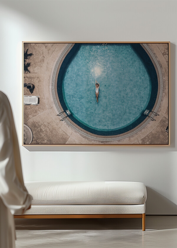 YOUNG ATTRACTIVE WOMAN FLOATS ON THE BACK IN THE ROUND BLUE POOL