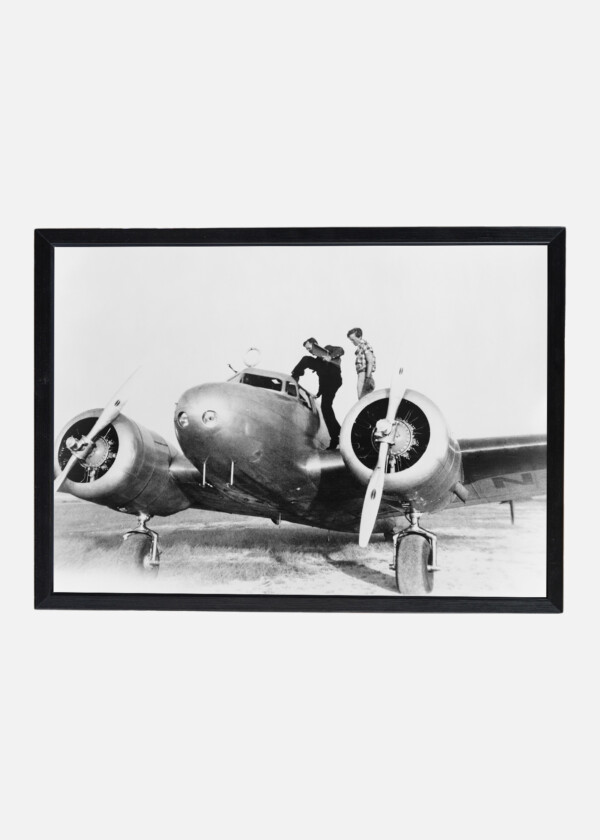 AMELIA EARHART ON WING OF HER LOCKHEED L-10E ELECTRA AIRPLANE