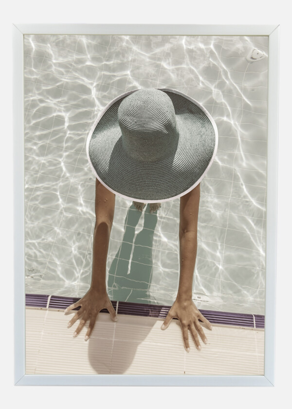 WOMAN IN SUN HAT IN THE SWIMMING POOL. TOP VIEW. VINTAGE STYLE