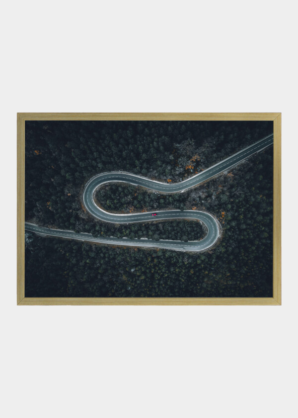 AERIAL VIEW OF A CAR ON A WINDING ROAD IN RURAL SPAIN